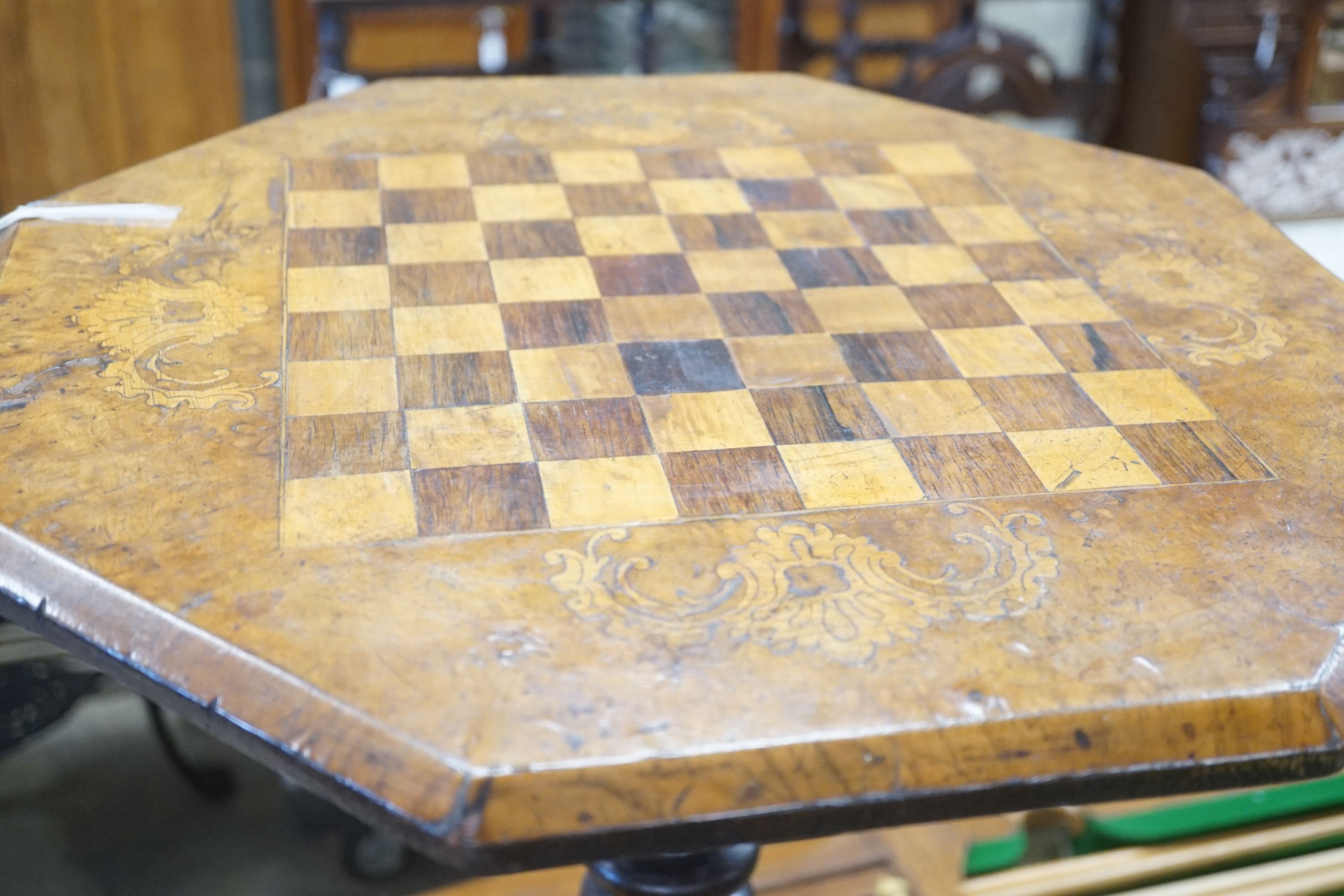 A Victorian octagonal walnut tripod games table, width 50cm height 67cm